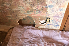 Photo of hole in bedroom wall